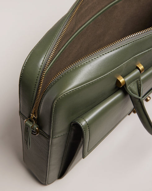 KALBE-Bags-Where the morning commute meets refined styling, there's KALBE. With plenty of room for your laptop and a convenient slip that attaches to trolley luggage, this document bag is perfect for on the go. Business trips: sorted. Document bag Top grain leather Front pocket Two top handles Trunk lock hardware Adjustable shoulder strap 15" laptop compartment Luggage trolley handle- Ted Baker Romania